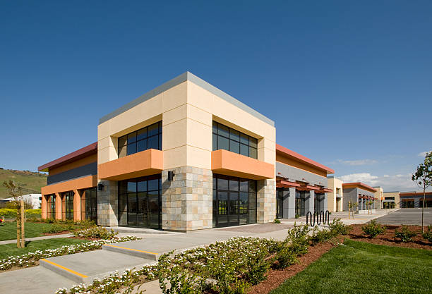 Building exterior with warm beige wall panels, dark bronze accents, and crisp white trim by a painting company in Baltimore County, MD.