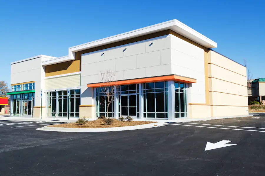 Commercial building with clean white, beige, and orange exterior finishes by a painting company in Owings Mills, MD.