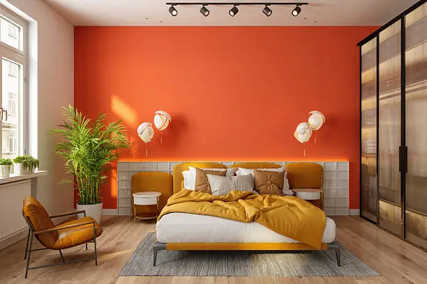 Bedroom with a bold terracotta accent wall in a matte finish by a house painter in Carroll County, MD.