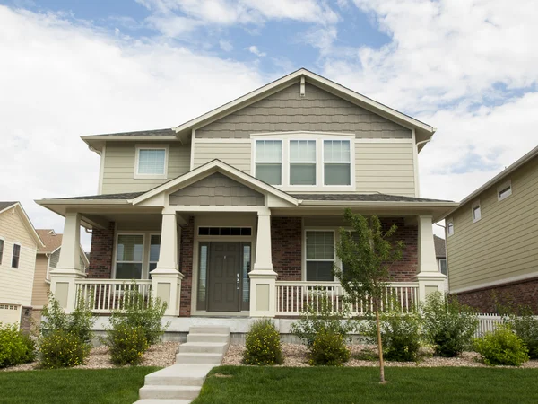 Home with sage green exterior siding and cream trim by a painter in Carroll County, MD.
