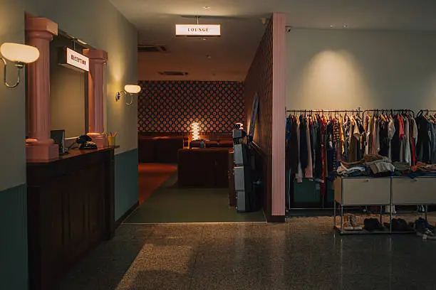 Retail clothing store interior with dark olive-green walls and wood trim by a painting company in Catonsville, MD.